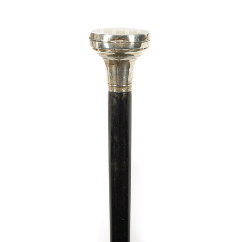 400 - A GEORGE V TAPERING EBONISED SWAGGER STICK the large ringed silver top with mirrored hinged recess a... 