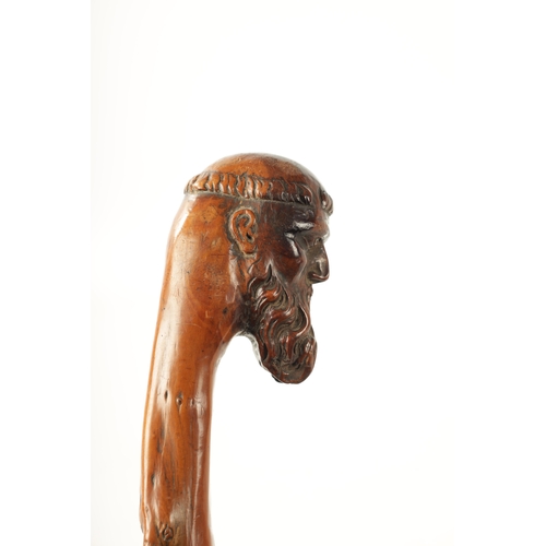 401 - A LATE 18TH/EARLY 19TH CENTURY CARVED ROOTWOOD WALKING STICK the carved monk's head handle above haw... 