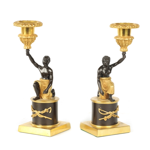 403 - A PAIR OF FRENCH EMPIRE BRONZE AND ORMOLU BLACKAMOOR CANDLESTICKS modelled as kneeling male and fema... 