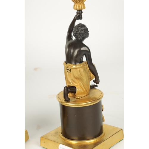 403 - A PAIR OF FRENCH EMPIRE BRONZE AND ORMOLU BLACKAMOOR CANDLESTICKS modelled as kneeling male and fema... 