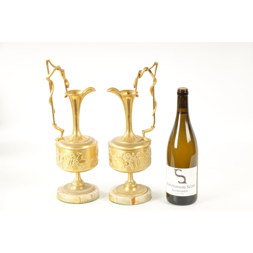 408 - A PAIR OF LATE 19TH CENTURY FRENCH GILT BRONZE CLASSICAL EWERS ON ALABASTER BASES with slender flare... 