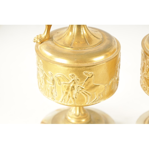 408 - A PAIR OF LATE 19TH CENTURY FRENCH GILT BRONZE CLASSICAL EWERS ON ALABASTER BASES with slender flare... 