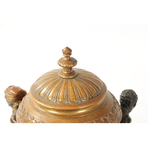 412 - A 19TH CENTURY COLD PAINTED BRONZE TABLE CENTRE PIECE with embossed lidded urn supported by three fi... 