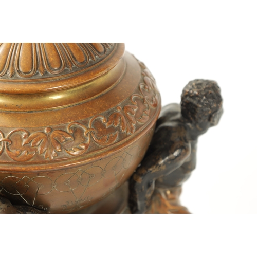 412 - A 19TH CENTURY COLD PAINTED BRONZE TABLE CENTRE PIECE with embossed lidded urn supported by three fi... 