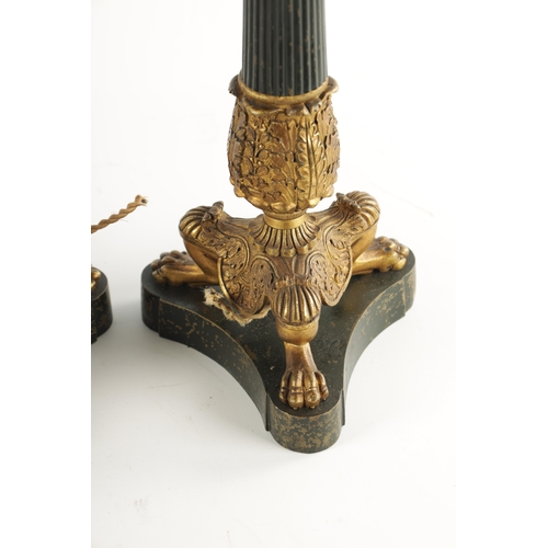 419 - A PAIR OF REGENCY STYLE BRONZE AND ORMOLU LAMP BASES with leaf cast reeded tapering stems; raised on... 