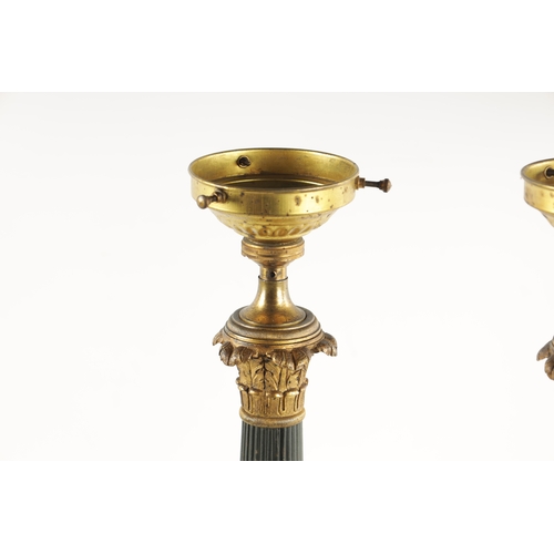 419 - A PAIR OF REGENCY STYLE BRONZE AND ORMOLU LAMP BASES with leaf cast reeded tapering stems; raised on... 