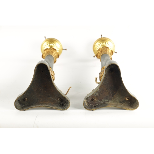 419 - A PAIR OF REGENCY STYLE BRONZE AND ORMOLU LAMP BASES with leaf cast reeded tapering stems; raised on... 