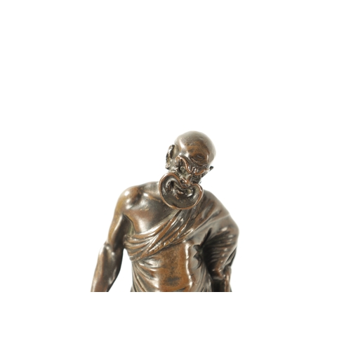 424 - A 19TH CENTURY FIGURAL BRONZE SCULPTURE modelled as a philosopher with grotesque mask, inscribed 