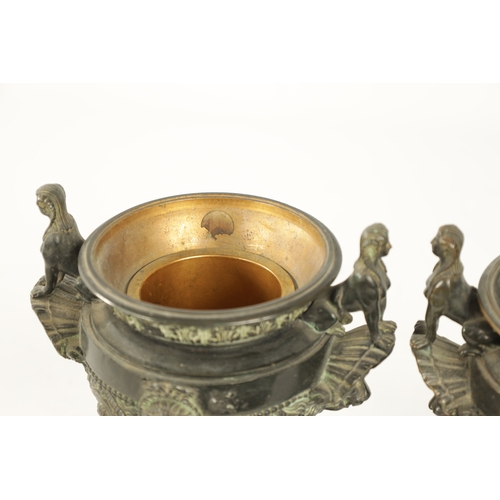 426 - A PAIR OF LATE 19TH CENTURY CAST BRONZE EGYPTIAN STYLE URNS with seated sphinx and lions mask side h... 