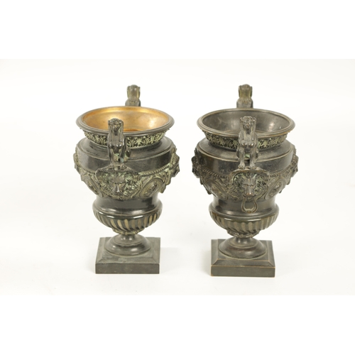 426 - A PAIR OF LATE 19TH CENTURY CAST BRONZE EGYPTIAN STYLE URNS with seated sphinx and lions mask side h... 