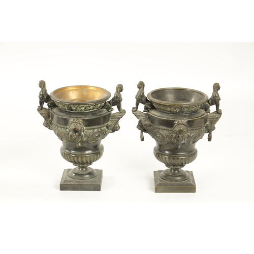 426 - A PAIR OF LATE 19TH CENTURY CAST BRONZE EGYPTIAN STYLE URNS with seated sphinx and lions mask side h... 