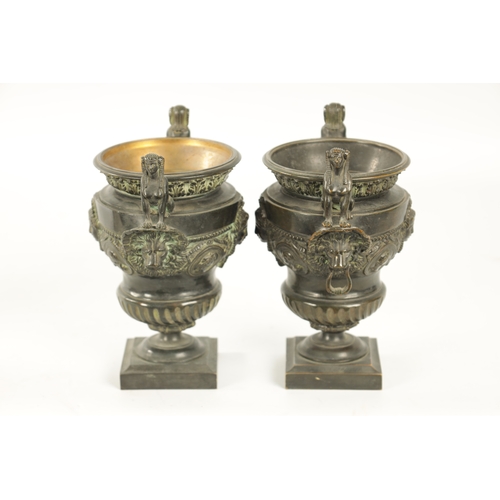 426 - A PAIR OF LATE 19TH CENTURY CAST BRONZE EGYPTIAN STYLE URNS with seated sphinx and lions mask side h... 