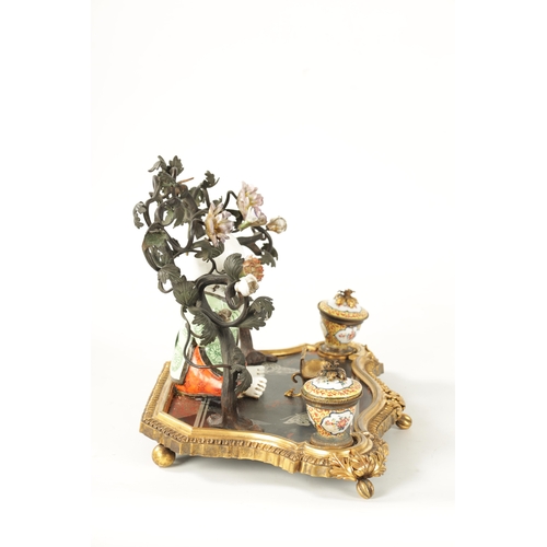 434 - A 19TH CENTURY CONTINENTAL ORMOLU, LACQUERWORK AND PORCELAIN PEN AND INK STAND with seated porcelain... 