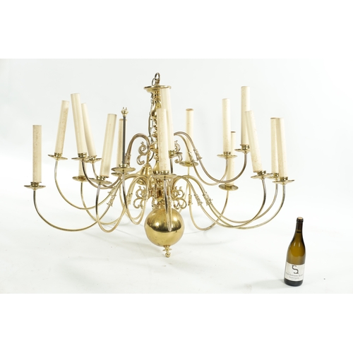 454 - A LARGE 20TH CENTURY BRASS HANGING LIGHT with shaped arms holding eighteen candle lights, with bulbo... 