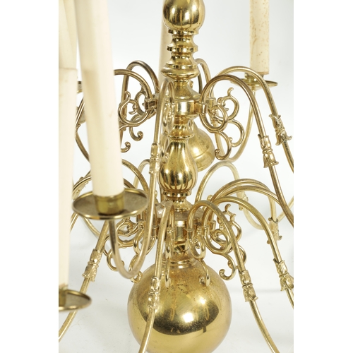 454 - A LARGE 20TH CENTURY BRASS HANGING LIGHT with shaped arms holding eighteen candle lights, with bulbo... 