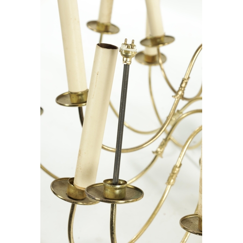 454 - A LARGE 20TH CENTURY BRASS HANGING LIGHT with shaped arms holding eighteen candle lights, with bulbo... 