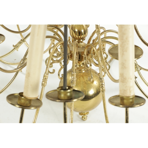 454 - A LARGE 20TH CENTURY BRASS HANGING LIGHT with shaped arms holding eighteen candle lights, with bulbo... 