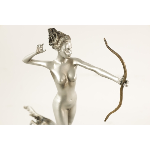 455 - AN ART DECO STYLE FIGURAL SILVERED BRONZE SCULPTURE modelled as Diana the huntress standing on a slo... 