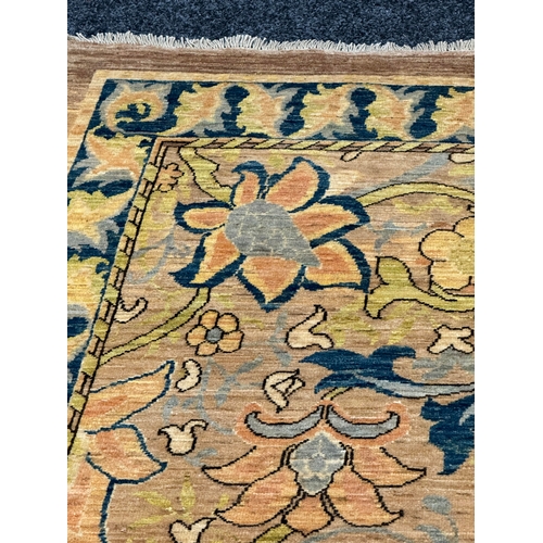 460 - A FINE CARPET OF ARTS AND CRAFTS DESIGN beige ground with overall design of bold multicoloured flowe... 