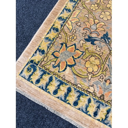 460 - A FINE CARPET OF ARTS AND CRAFTS DESIGN beige ground with overall design of bold multicoloured flowe... 