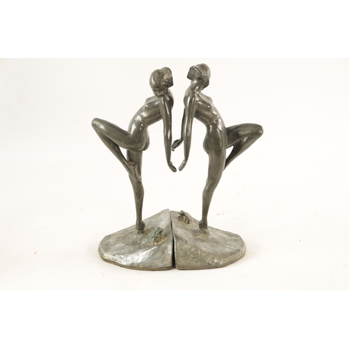 467 - A PAIR OF ART NOVEAU PEWTER FIGURAL BOOKENDS modelled as nude dancing girls standing on naturalist b... 