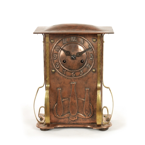 652 - AN ARTS AND CRAFT COPPER AND BRASS MANTEL CLOCK the planished case with domed top and relief Arabic ... 