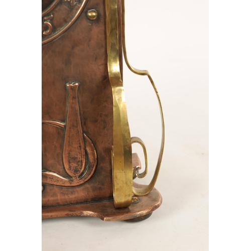 652 - AN ARTS AND CRAFT COPPER AND BRASS MANTEL CLOCK the planished case with domed top and relief Arabic ... 