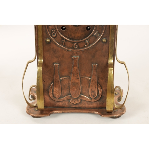 652 - AN ARTS AND CRAFT COPPER AND BRASS MANTEL CLOCK the planished case with domed top and relief Arabic ... 