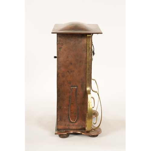 652 - AN ARTS AND CRAFT COPPER AND BRASS MANTEL CLOCK the planished case with domed top and relief Arabic ... 