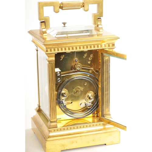 658 - A LATE 19TH CENTURY FRENCH BRASS CASED REPEATING CARRIAGE CLOCK with filigree masked dial, having an... 