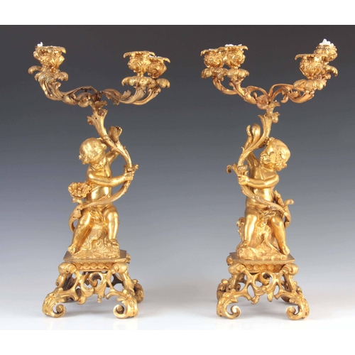 466 - A PAIR OF 19TH CENTURY GILT ORMOLU BRONZE FOUR BRANCH CANDELABRA with leaf and branchwork tops suppo... 