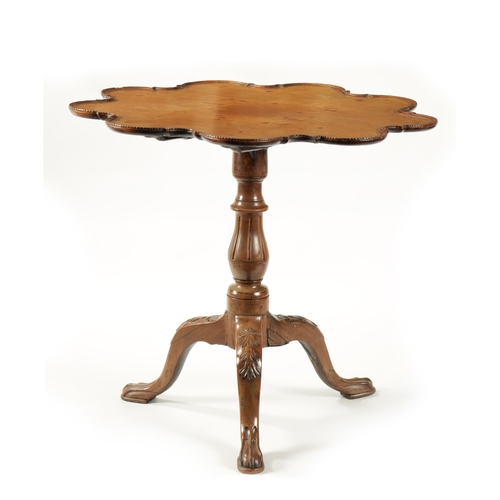 58 - A GEORGE III MAHOGANY TILT TOP TABLE with scalloped moulded edge top; raised on a carved cabriole ba... 