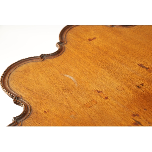 58 - A GEORGE III MAHOGANY TILT TOP TABLE with scalloped moulded edge top; raised on a carved cabriole ba... 