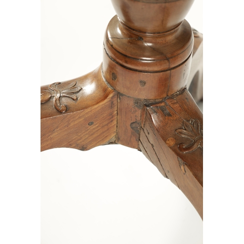 58 - A GEORGE III MAHOGANY TILT TOP TABLE with scalloped moulded edge top; raised on a carved cabriole ba... 