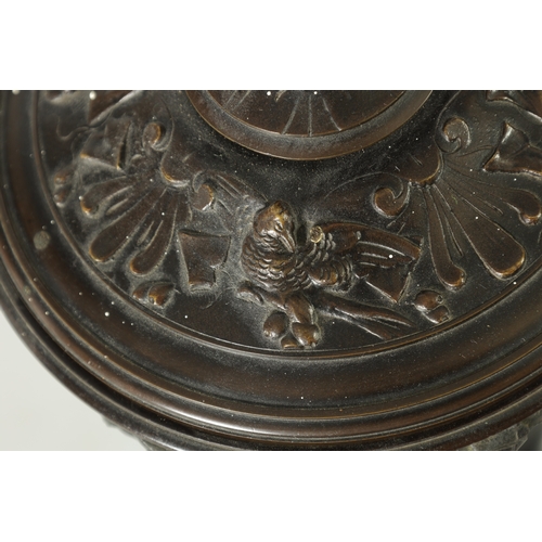 90 - A 19TH CENTURY BRONZE LIDDED TAZZA with figural finial and stylised floral decoration, raised on a g... 