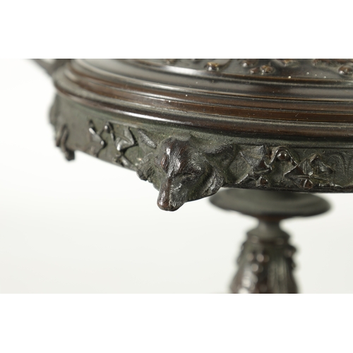 90 - A 19TH CENTURY BRONZE LIDDED TAZZA with figural finial and stylised floral decoration, raised on a g... 