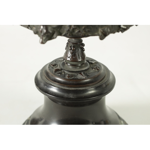 90 - A 19TH CENTURY BRONZE LIDDED TAZZA with figural finial and stylised floral decoration, raised on a g... 