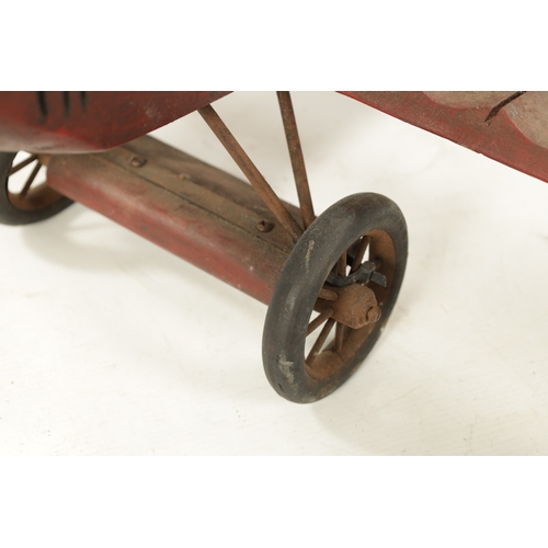 1 - A VINTAGE MODEL AEROPLANE with red paint and rubber wheels (75cm across 70cm overall)