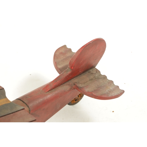 1 - A VINTAGE MODEL AEROPLANE with red paint and rubber wheels (75cm across 70cm overall)