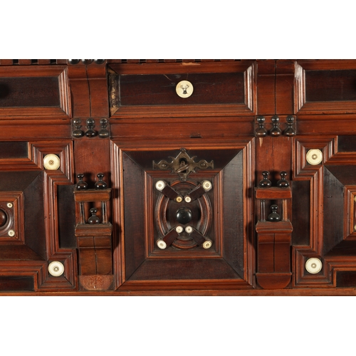 110 - A 17TH CENTURY TWO PART MOULDED FRONT YEW-WOOD, WALNUT AND EBONY CHEST OF DRAWERS with turned moulde... 