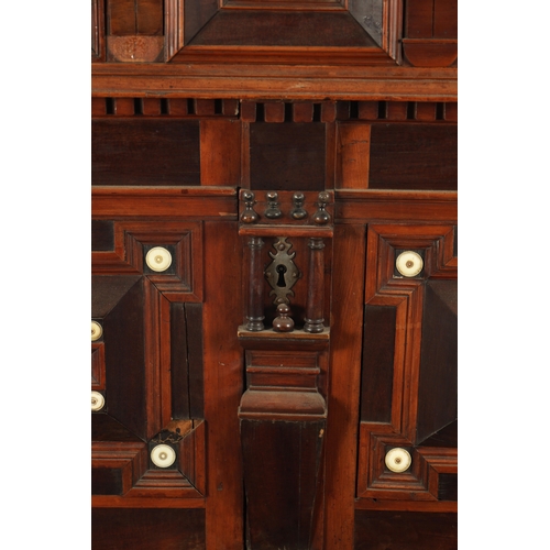 110 - A 17TH CENTURY TWO PART MOULDED FRONT YEW-WOOD, WALNUT AND EBONY CHEST OF DRAWERS with turned moulde... 