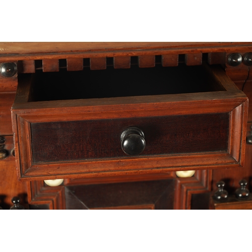 110 - A 17TH CENTURY TWO PART MOULDED FRONT YEW-WOOD, WALNUT AND EBONY CHEST OF DRAWERS with turned moulde... 