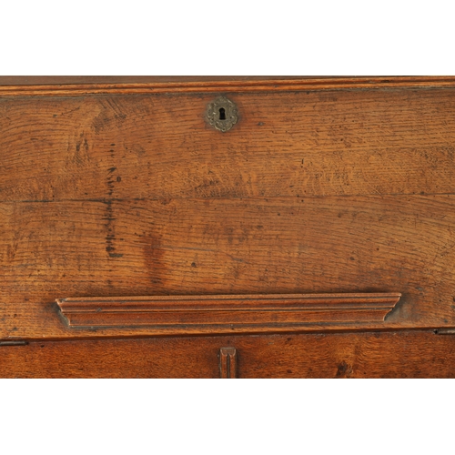 124 - AN EARLY 18TH CENTURY FIGURED OAK COUNTRY MADE BUREAU with fitted hinged fall above a bank of two sm... 