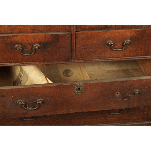 124 - AN EARLY 18TH CENTURY FIGURED OAK COUNTRY MADE BUREAU with fitted hinged fall above a bank of two sm... 