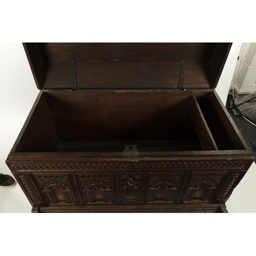 132 - AN EARLY 18TH CENTURY FLEMISH OAK KIST DATED 1718 having superb colour and patina with carved arcade... 