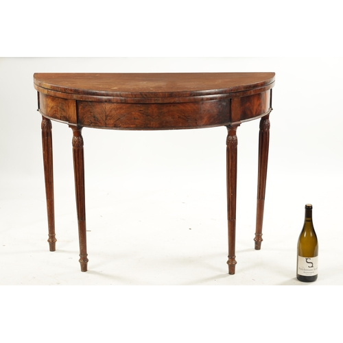 143 - A LATE 18TH CENTURY DEMI LUNE CARD TABLE ON FLUTED LEGS IN THE MANNER OF GILLOWS with cross-banded t... 