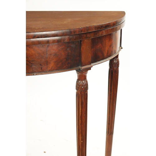 143 - A LATE 18TH CENTURY DEMI LUNE CARD TABLE ON FLUTED LEGS IN THE MANNER OF GILLOWS with cross-banded t... 