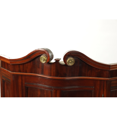 153 - A 19TH CENTURY MAHOGANY SERPENTINE FRONTED HANGING CORNER CUPBOARD IN THE MANNER OF DUNCAN PHYFE wit... 