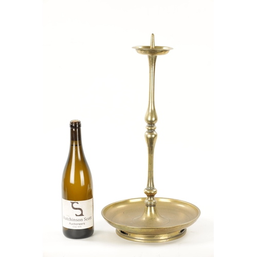 167 - A 19TH CENTURY EASTERN BRASS CANDLESTICK with circular engraved base. (52cm high)