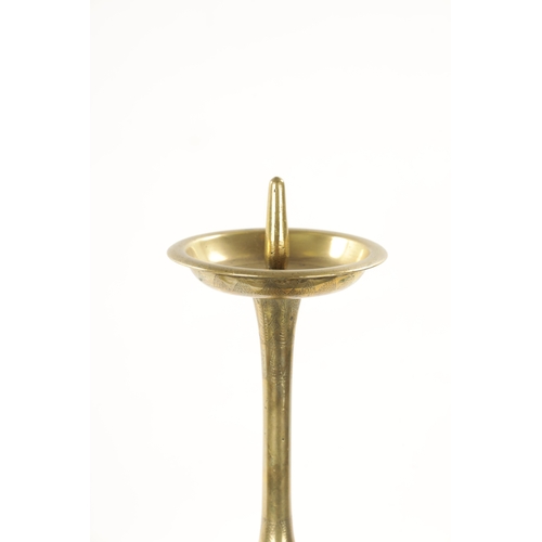 167 - A 19TH CENTURY EASTERN BRASS CANDLESTICK with circular engraved base. (52cm high)